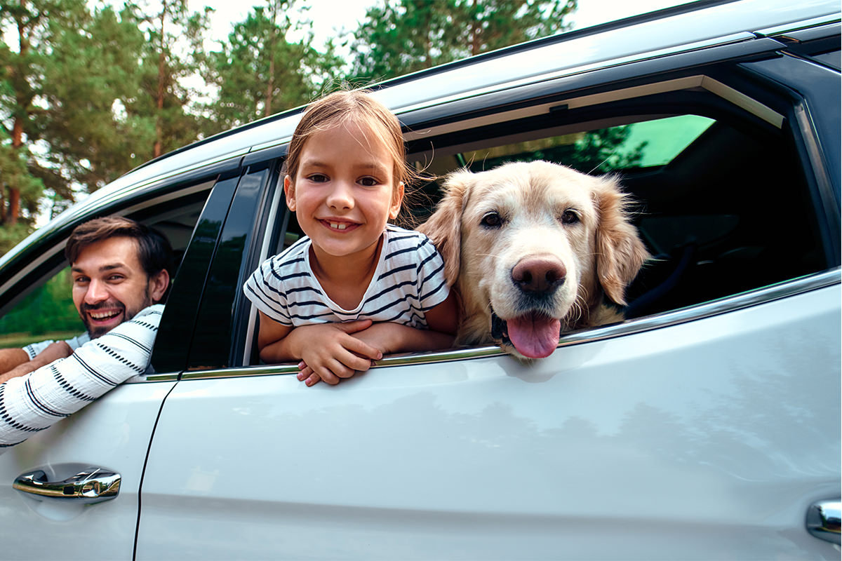 father daughter with dog in car