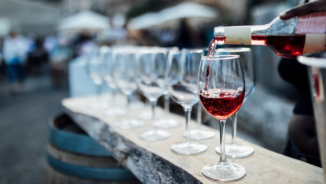 pouring red wine in festival