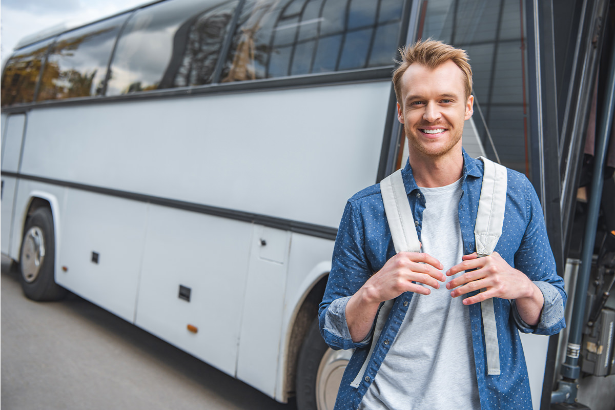 man in front of bus